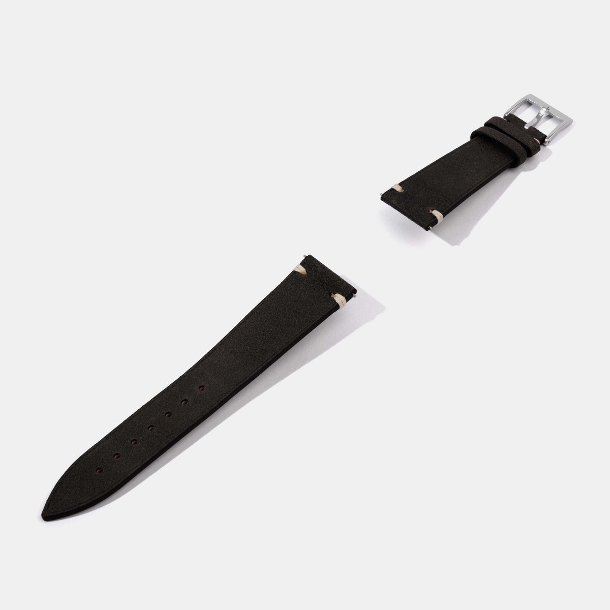 A black leather watch strap with a silver buckle, shown in a clean studio shot on a light gray background.